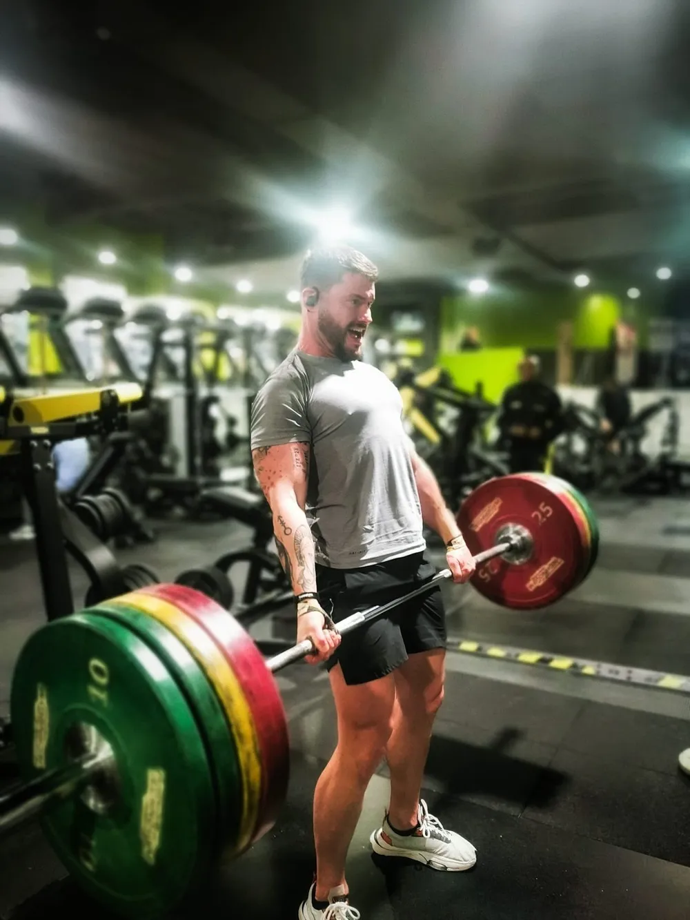 Alex deadlifting a loaded barbell