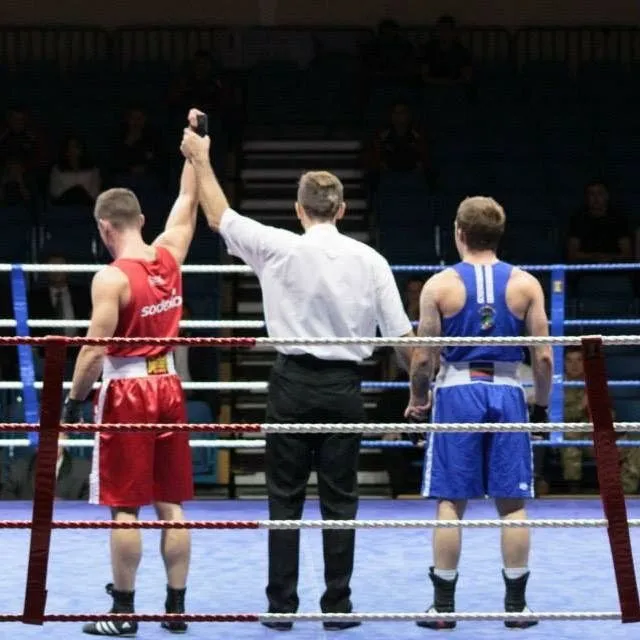 Alex's hand raised by the referee after a bout